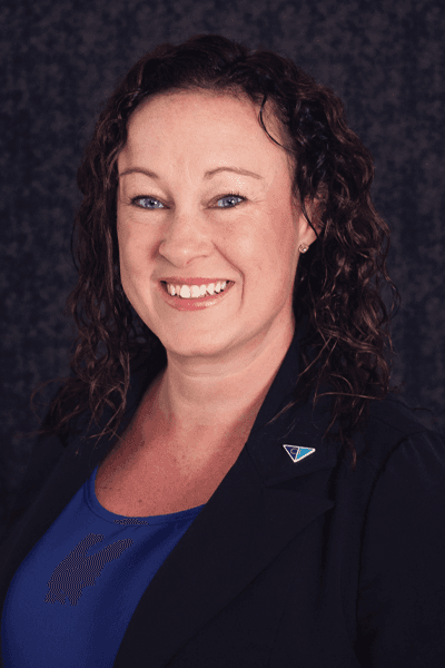 Croghan Bank employee smiling in a black blazer with a blue triangle pin