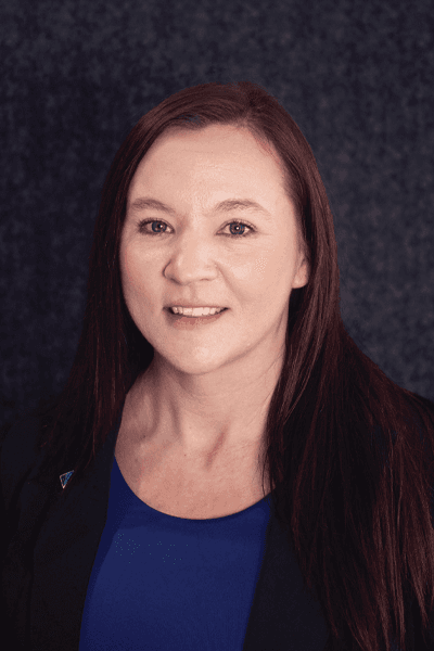 Smiling Croghan Bank professional woman with long dark hair wearing a black blazer and blue top