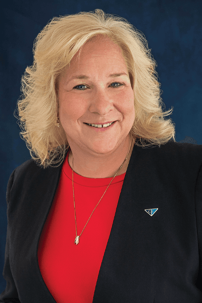 Smiling Croghan Bank female staff member with blonde hair wearing a black blazer and red top