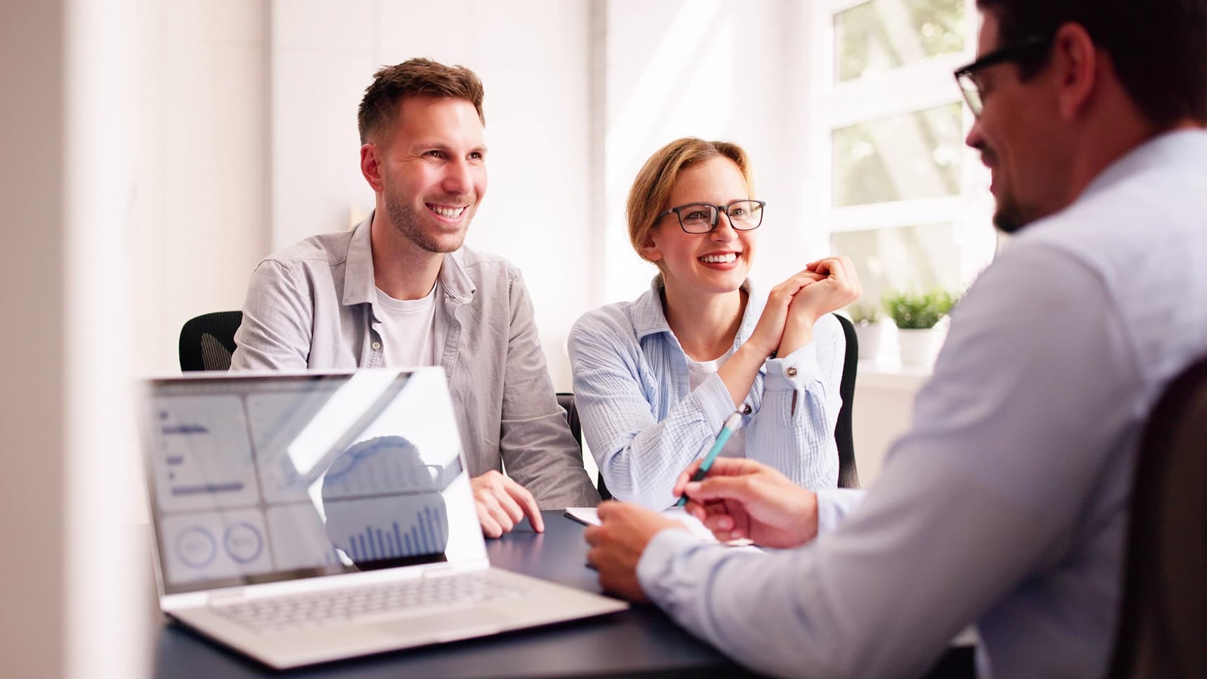 Couple meeting with a financial advisor to discuss home loan or financial planning options
