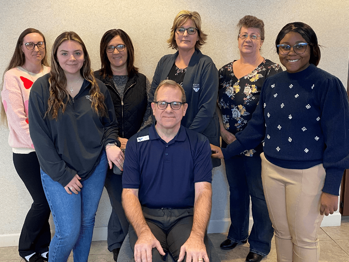 Croghan Bank team of seven employees smiling together in a professional office setting