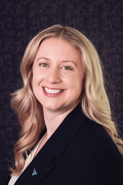 Croghan Bank professional woman with blonde hair smiling in a black blazer against a dark background