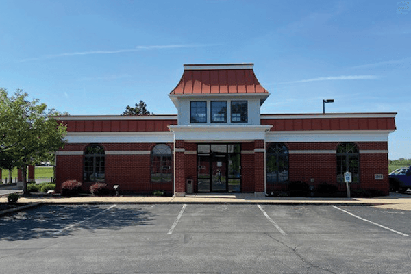 Croghan Colonial Bank branch front entrance with brick facade, arched windows, and copper-topped cupola