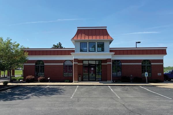 Croghan Colonial Bank branch front entrance with brick facade, arched windows, and copper-topped cupola