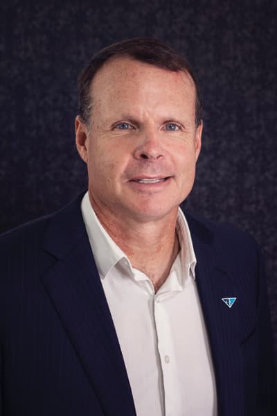 Croghan Bank professional in a navy pinstripe blazer with a blue triangle pin