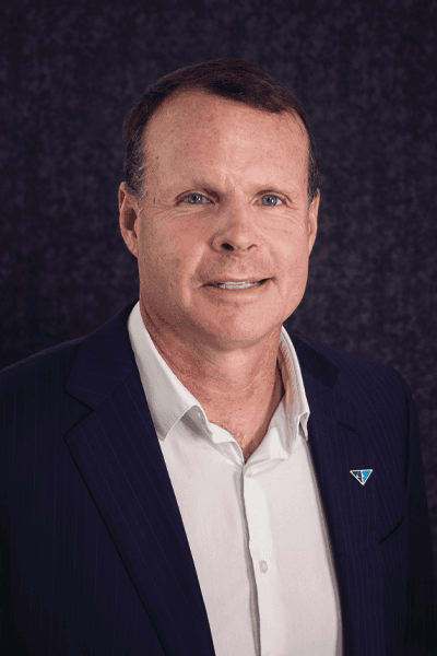Croghan Bank professional in a navy pinstripe blazer with a blue triangle pin