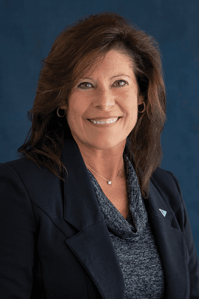 Croghan Bank team member in a black blazer with a blue triangle pin, smiling
