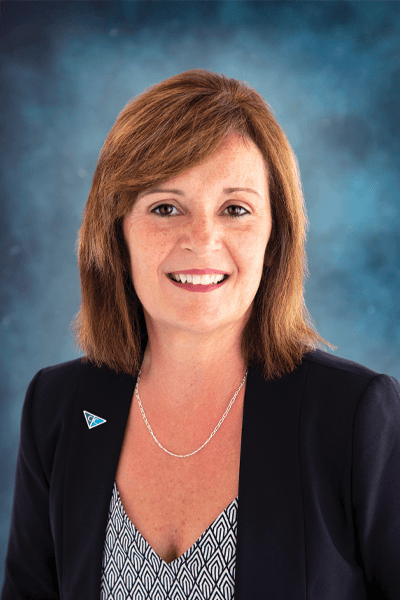Smiling Croghan Bank female staff member with auburn hair wearing a black blazer and patterned top