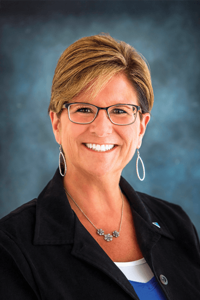 Smiling Croghan Bank professional woman with short blonde hair, glasses, and a black blazer