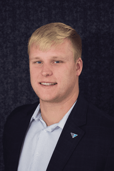 Smiling young man with blonde hair in a navy blazer with a Croghan Bank pin
