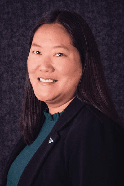 Croghan Bank professional in a black blazer with a teal top, smiling warmly