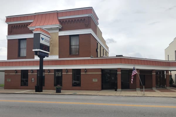 Croghan Colonial Bank two-story brick corner branch with copper roof trim and digital sign