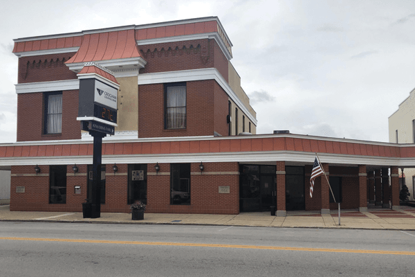 Croghan Colonial Bank two-story brick corner branch with copper roof trim and digital sign