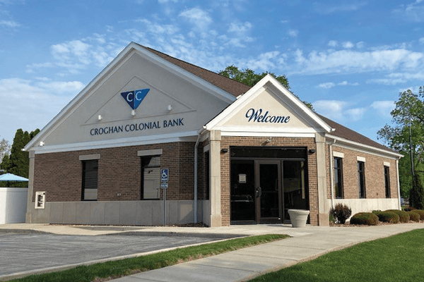 Croghan Colonial Bank branch exterior with "Welcome" signage, brick walls, and covered entrance