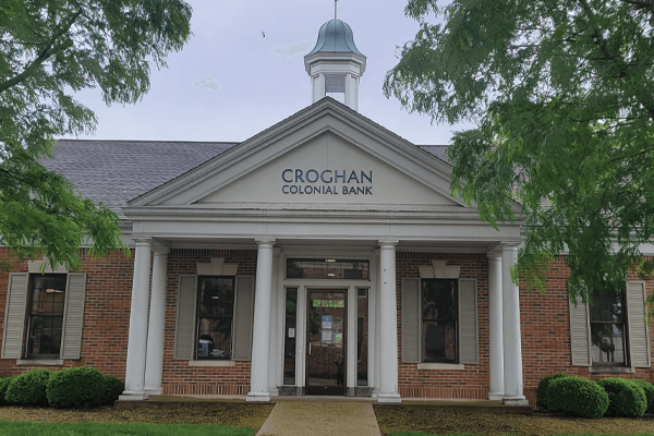 Croghan Colonial Bank branch with white colonial columns, cupola, and brick exterior