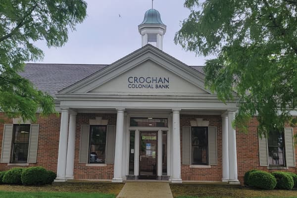 Croghan Colonial Bank branch with white colonial columns, cupola, and brick exterior