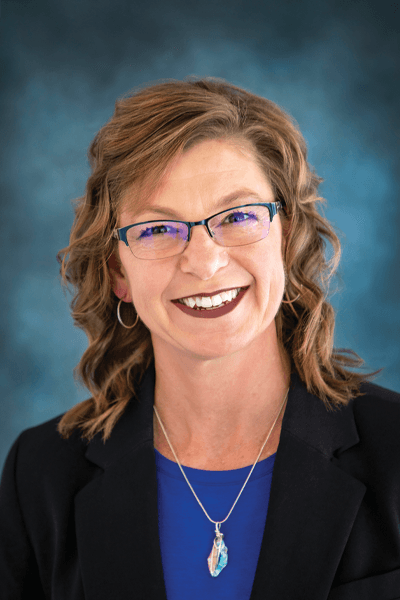 Croghan Bank team member smiling, wearing glasses and a blue top with a black blazer