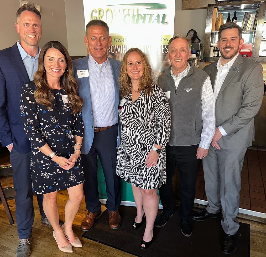 Croghan Bank team members smiling together at a Growtel Capital financial event