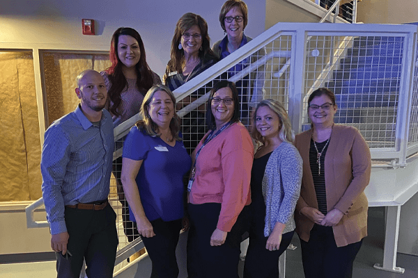 Group of Croghan Bank employees posing together on a staircase at a professional gathering