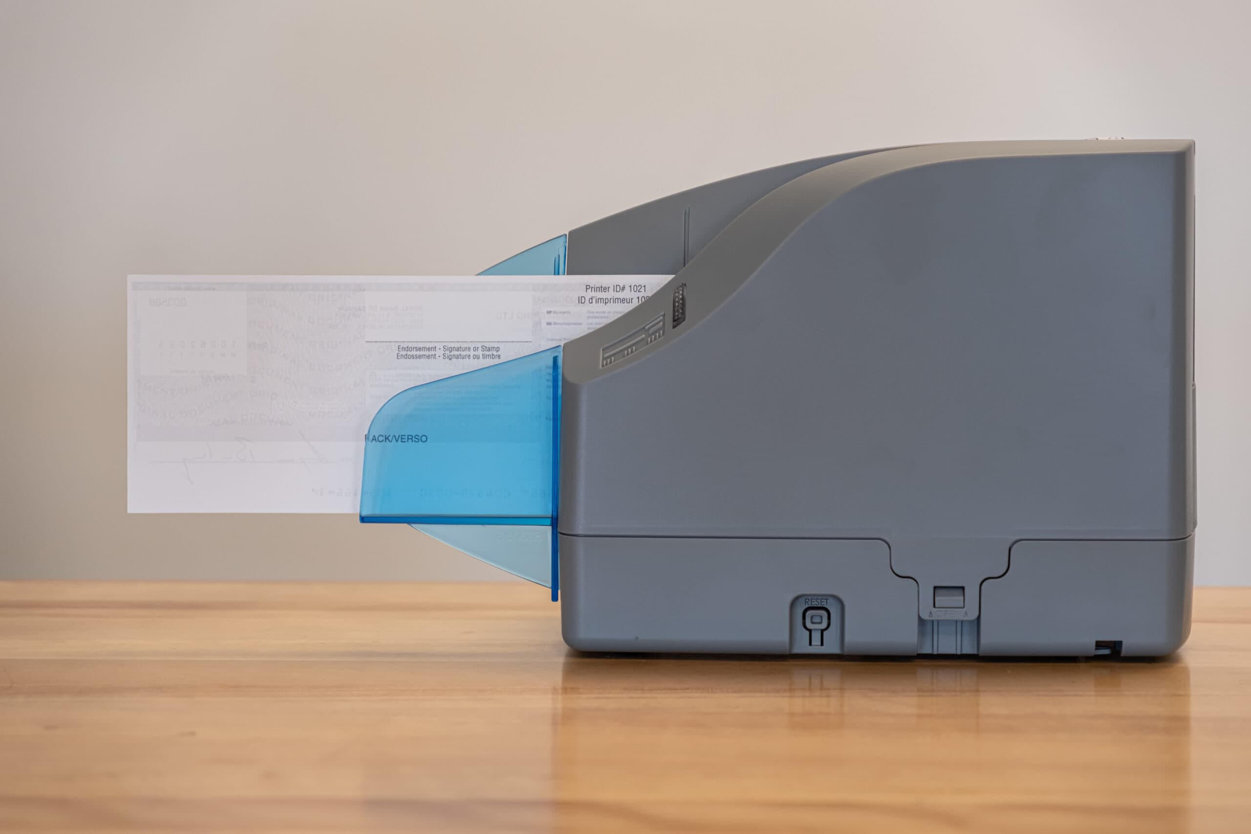 Check scanner processing a document for Croghan Bank online banking deposits