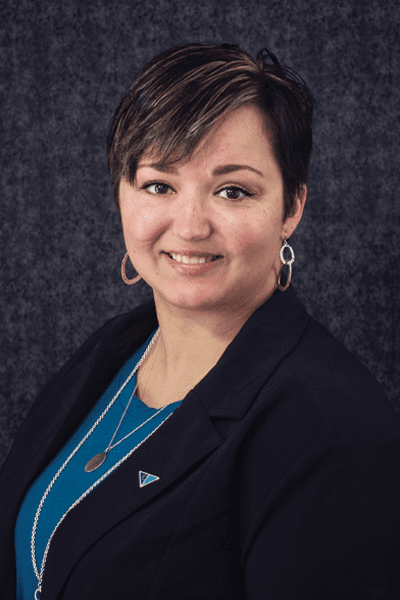 Croghan Bank employee with short dark hair wearing a teal top and black blazer