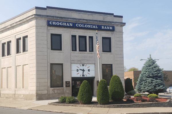 Croghan Colonial Bank main branch with stone exterior, large clock, and "Established 1888" inscription