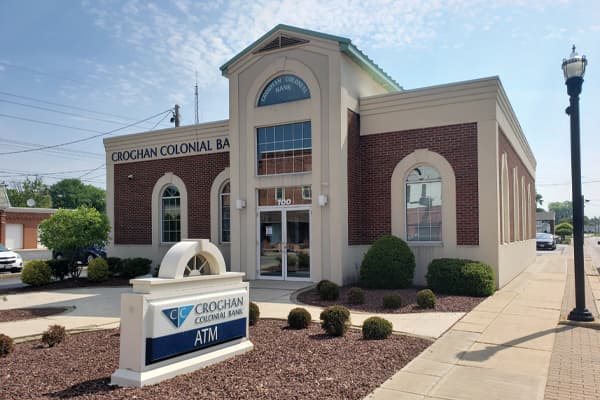 Croghan Colonial Bank branch featuring arched windows, brick facade, and ATM sign out front