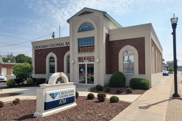 Croghan Colonial Bank branch featuring arched windows, brick facade, and ATM sign out front