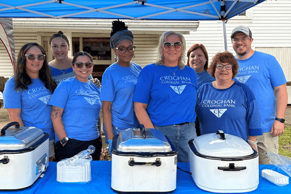 Croghan Colonial Bank team members serving food at an outdoor community volunteer event