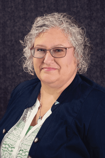 Croghan Bank staff member with curly gray hair and glasses wearing a navy blazer