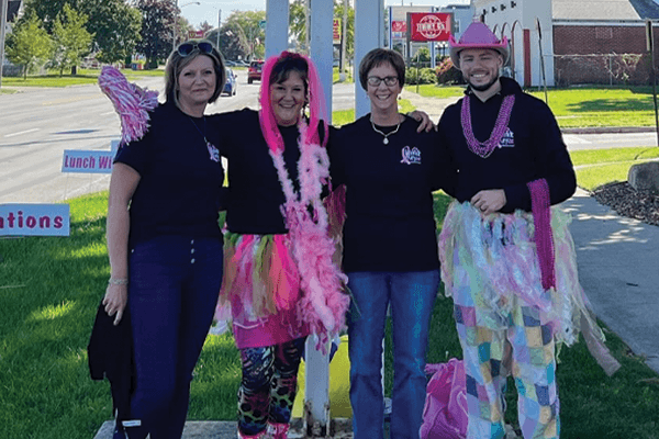 Four Croghan Colonial Bank staff members in festive costumes at an outdoor charity fundraiser