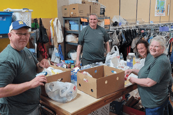 Croghan Bank volunteers sorting donated goods and food items at a community charity store