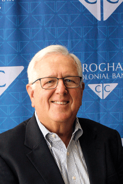 Smiling Croghan Colonial Bank representative in a dark blazer with glasses