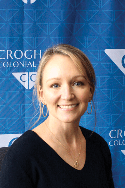 Smiling Croghan Colonial Bank employee in a black sweater