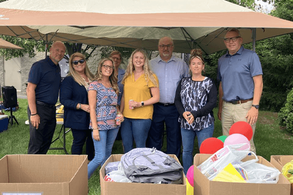 Croghan Colonial Bank staff volunteers at a community donation drive with boxes of school supplies and balloons