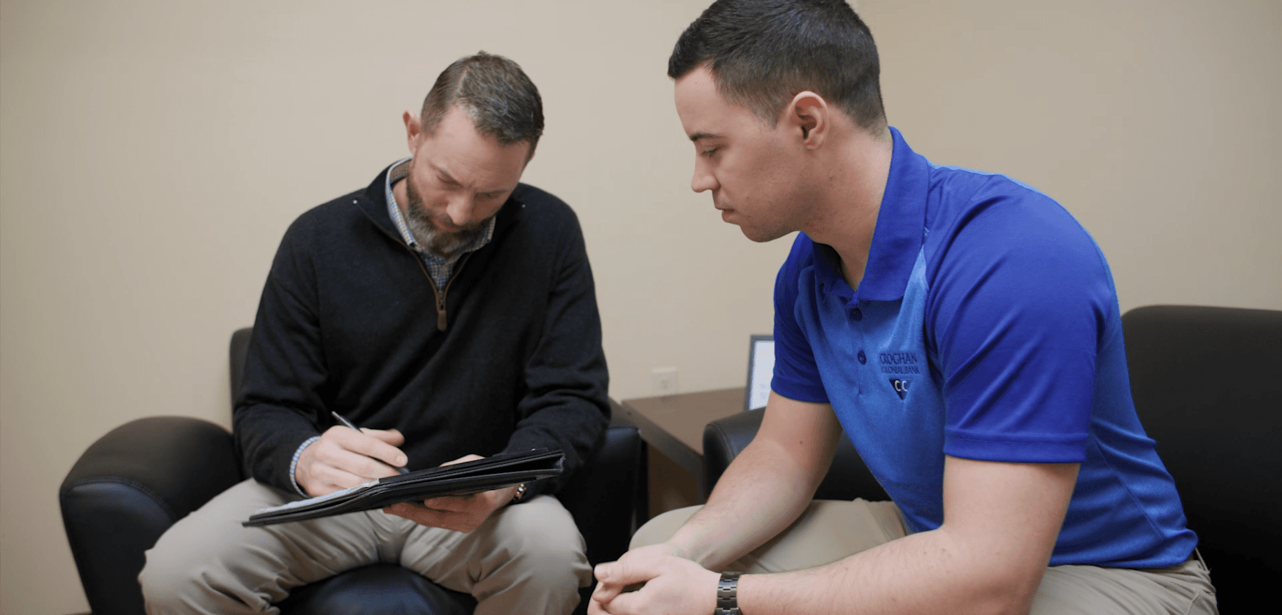 Croghan Colonial Bank employee reviewing documents with a client during a consultation