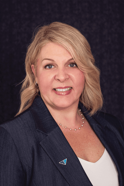 Smiling Croghan Bank professional woman with blonde hair wearing a gray blazer and pearl necklace