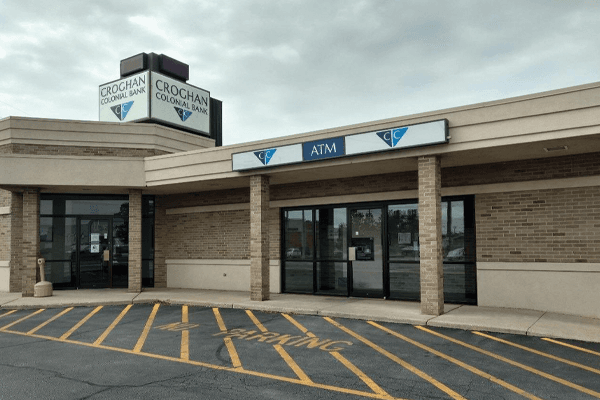Croghan Colonial Bank branch entrance with ATM and dual signage under overcast sky