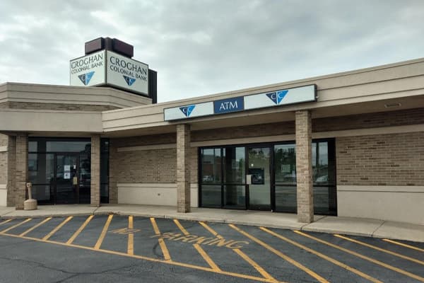 Croghan Colonial Bank branch entrance with ATM and dual signage under overcast sky