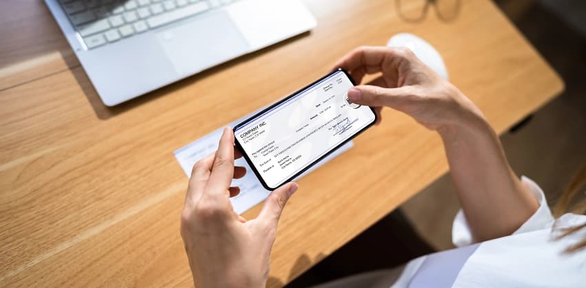 Person using a smartphone to deposit a check via mobile banking