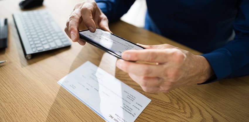 Man using a smartphone to deposit a check with mobile banking