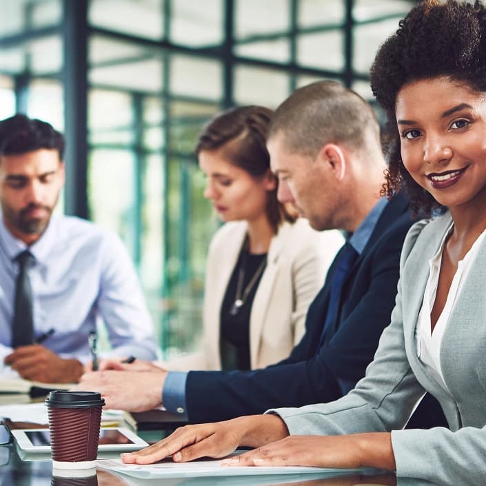 Diverse business professionals seated at a conference table during a meeting