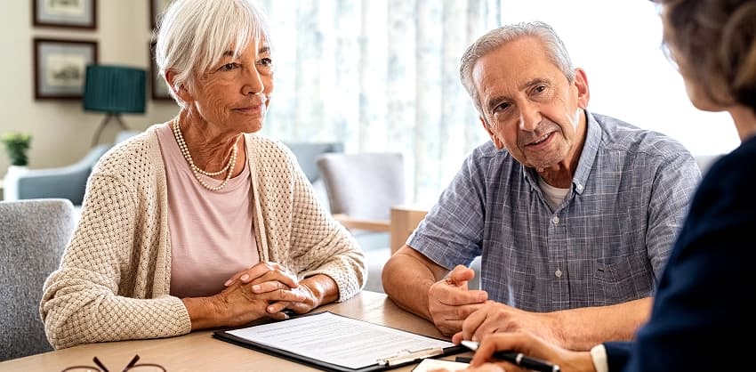 Couple consulting with a wealth management advisor about retirement planning and financial goals