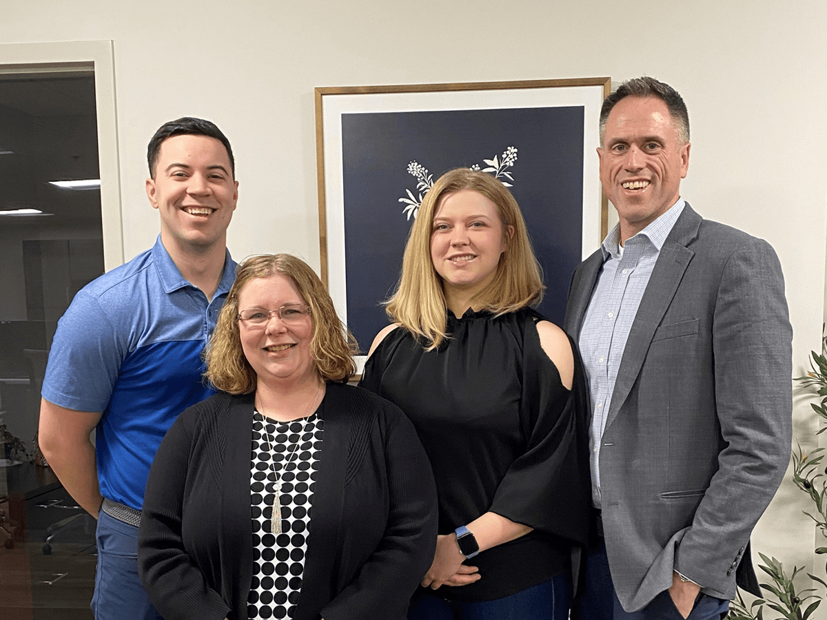 Four Croghan Bank team members smiling together in a professional office setting