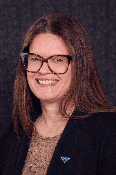 Croghan Bank team member smiling in professional attire with glasses