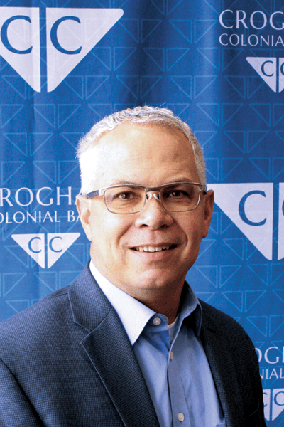 Croghan Colonial Bank representative smiling in front of branded backdrop
