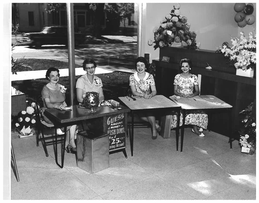 Vintage black and white photo of Croghan Colonial Bank staff seated at desks inside a banking office